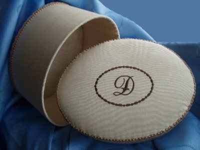 Oval box with embroidered initial