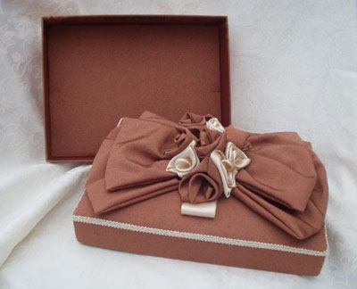 Rectangular box, bronze flax with cream roses